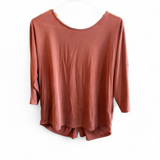 Green Envelope rust color womens small button back shirt hanging on white background