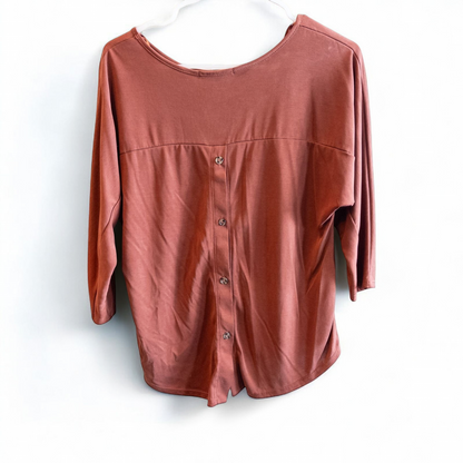 Green Envelope rust color womens small button back shirt hanging on white background image 2