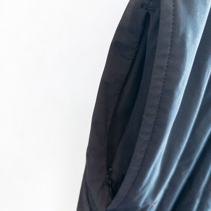 Rhone black athletic shorts for men with elastic waistband and zippered pockets hanging on hanger image 2