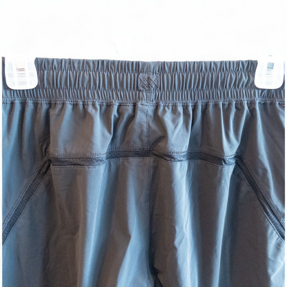 Rhone black athletic shorts for men with elastic waistband and zippered pockets hanging on hanger image 5