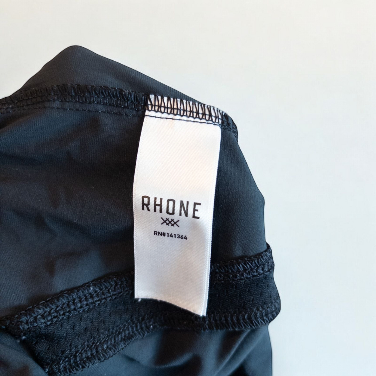 Rhone black athletic shorts for men with elastic waistband and zippered pockets hanging on hanger image 7