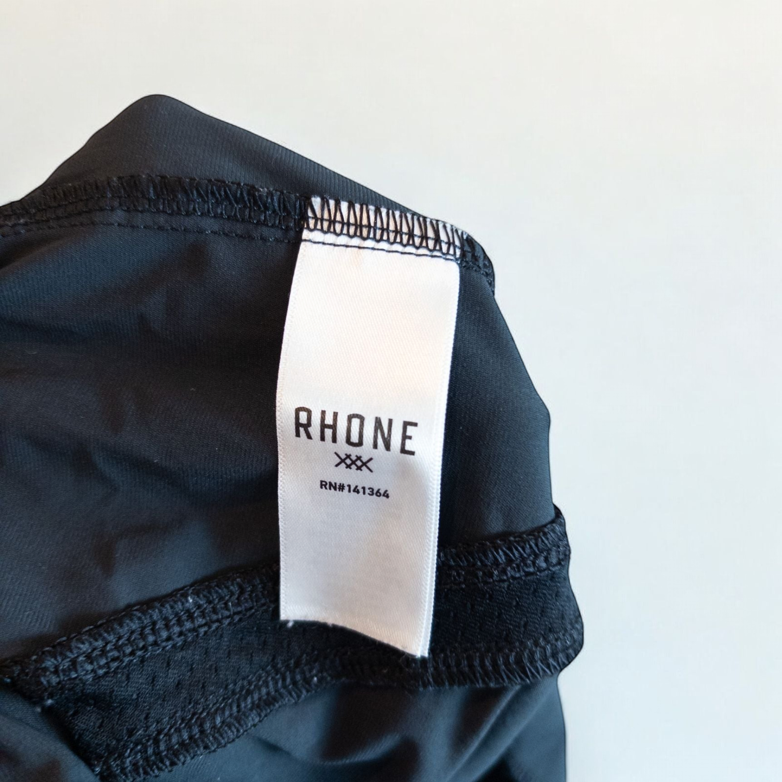 Rhone black athletic shorts for men with elastic waistband and zippered pockets hanging on hanger image 7