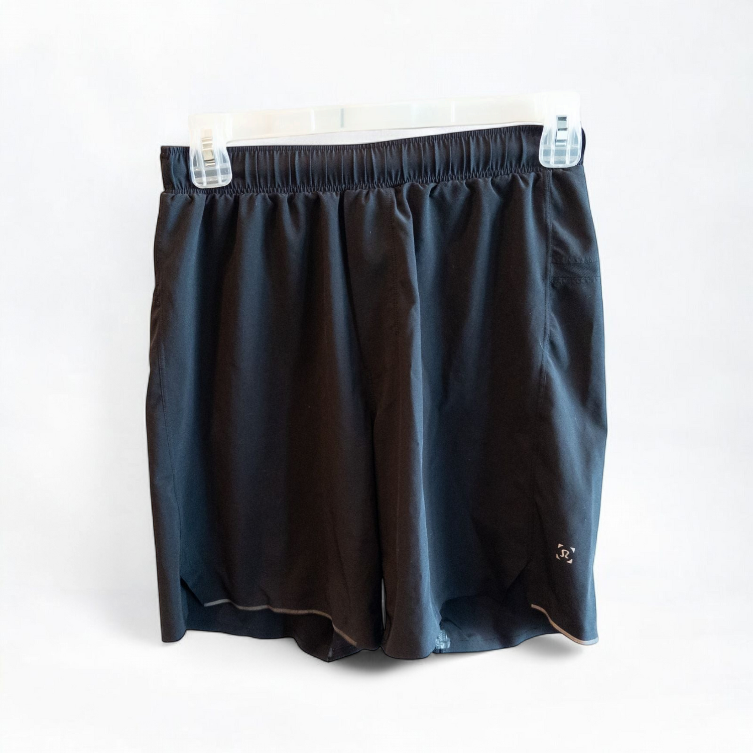 Black lululemon men's lightweight athletic shorts with elastic waistband and drawstring tie hanging on clips