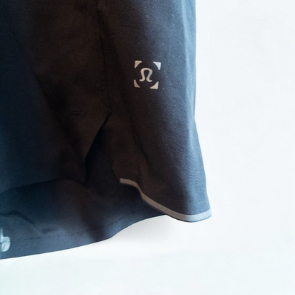 Black lululemon men's lightweight athletic shorts with elastic waistband and drawstring tie hanging on clips image 3