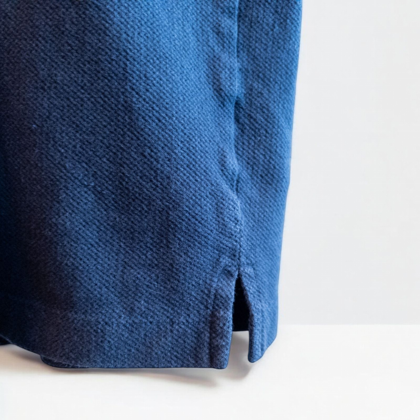 Blue Sunspel cotton polo shirt with short sleeves and chest pocket hanging on white hanger image 4