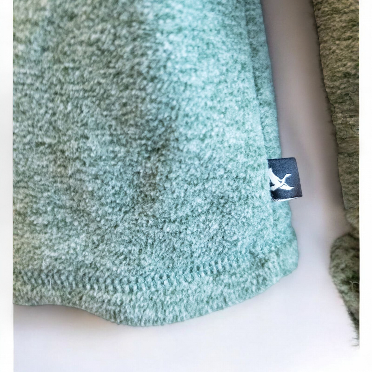 Eddie Bauer green quarter zip sweatshirt hanging on a plastic hanger showing front, back, collar, and inside label image 4