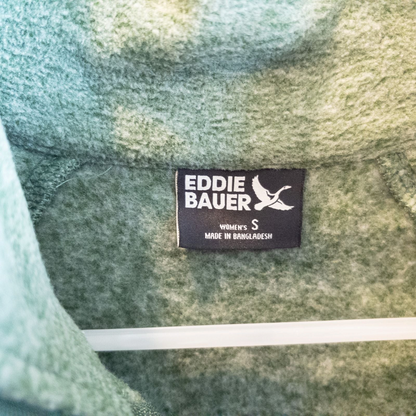 Eddie Bauer green quarter zip sweatshirt hanging on a plastic hanger showing front, back, collar, and inside label image 6