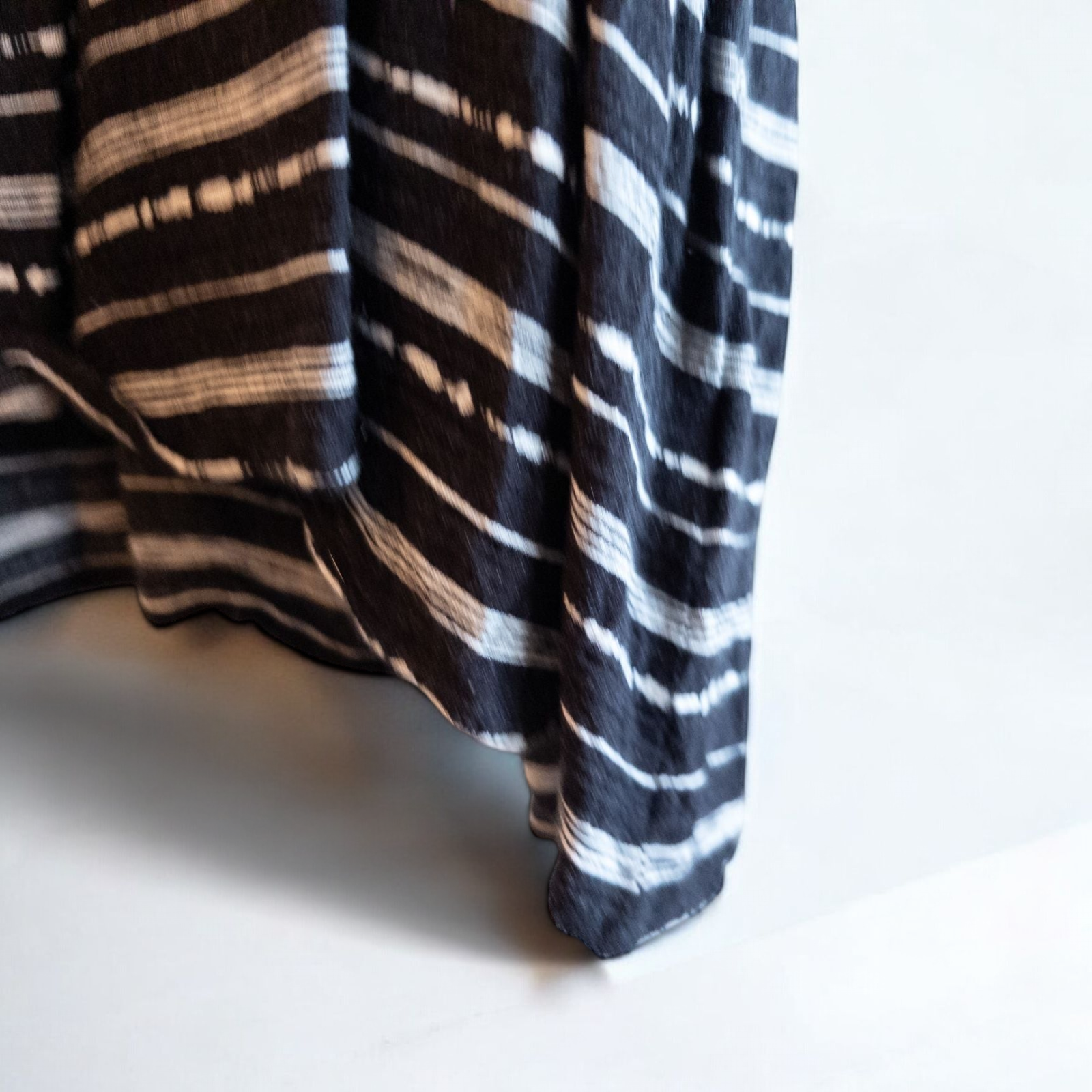 Paper Crane black and white striped peplum blouse with round neck and flutter sleeves hanging on white door image 3