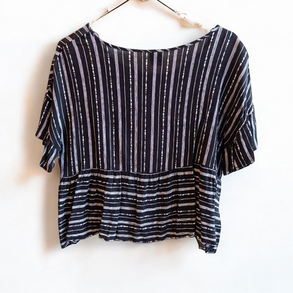 Paper Crane black and white striped peplum blouse with round neck and flutter sleeves hanging on white door image 4