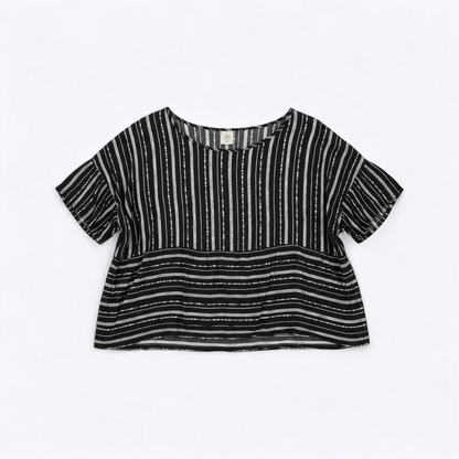 Paper Crane black and white striped peplum blouse with round neck and flutter sleeves hanging on white door front on white muslin photography backdrop