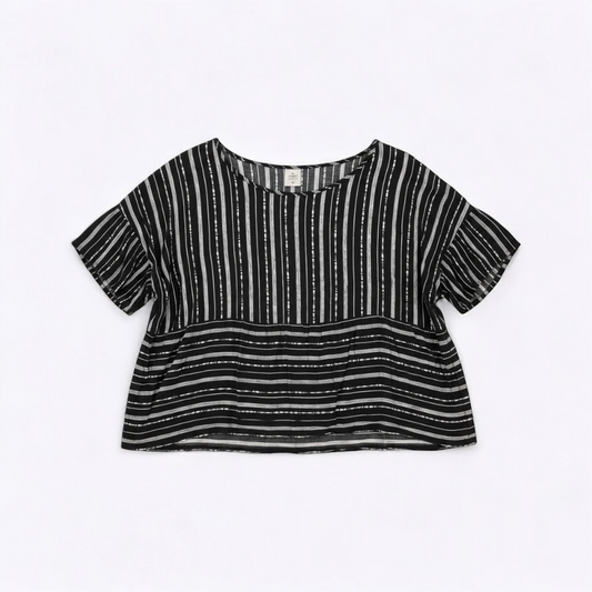 Paper Crane black and white striped peplum blouse with round neck and flutter sleeves hanging on white door front on white muslin photography backdrop