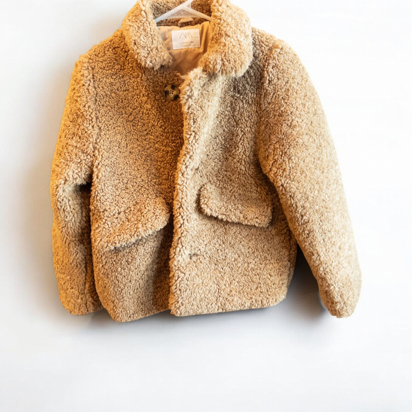 Zara brown teddy bear coat kids size 13 14 hanging on wall, showing front, back, inside lining and close up details of pockets and buttons image 3
