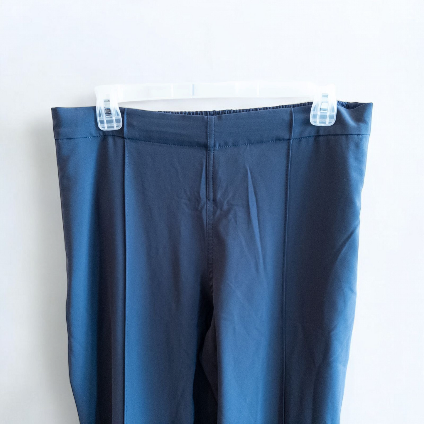Gray MM LaFleur tech pants hanging on a hanger front and back views with close up of waistband, zipper, and label image 2