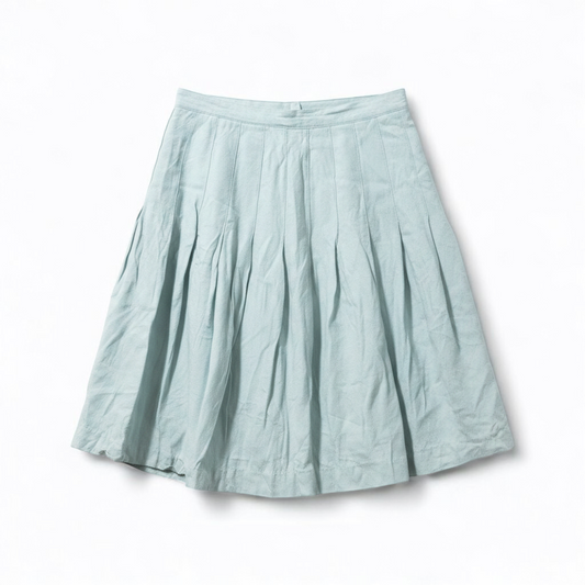 Casual Corner vintage pastel green pleated mini skirt with textured fabric hanging on clear hanger front on white muslin photography backdrop