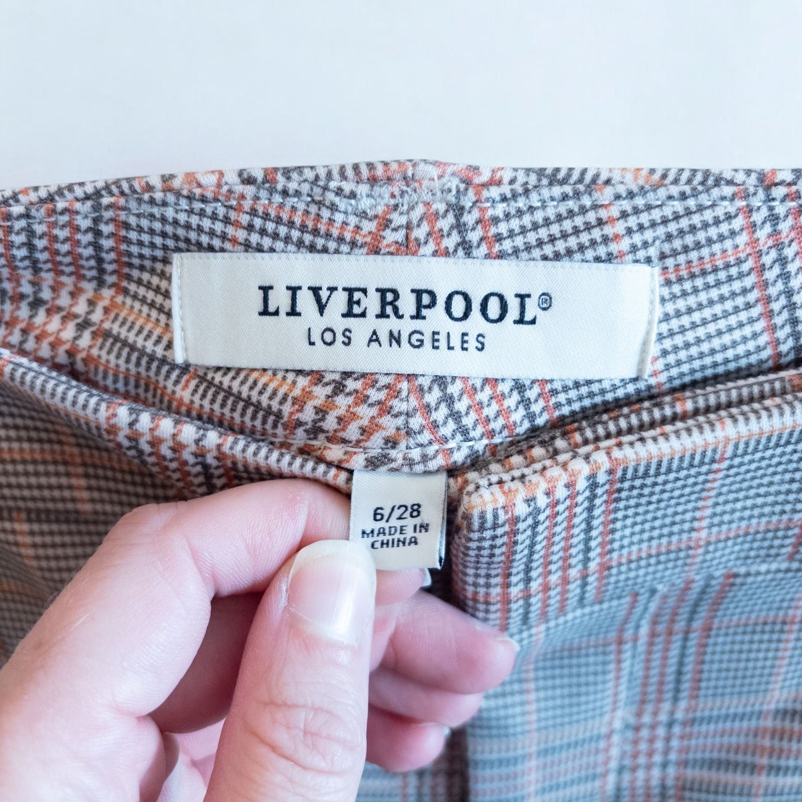 Liverpool Kelsey Lava Flow orange plaid straight leg trousers with tags hanging on white cabinet image 9