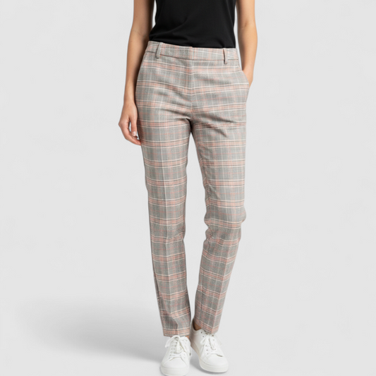 Liverpool Kelsey Lava Flow orange plaid straight leg trousers with tags hanging on white cabinet on model