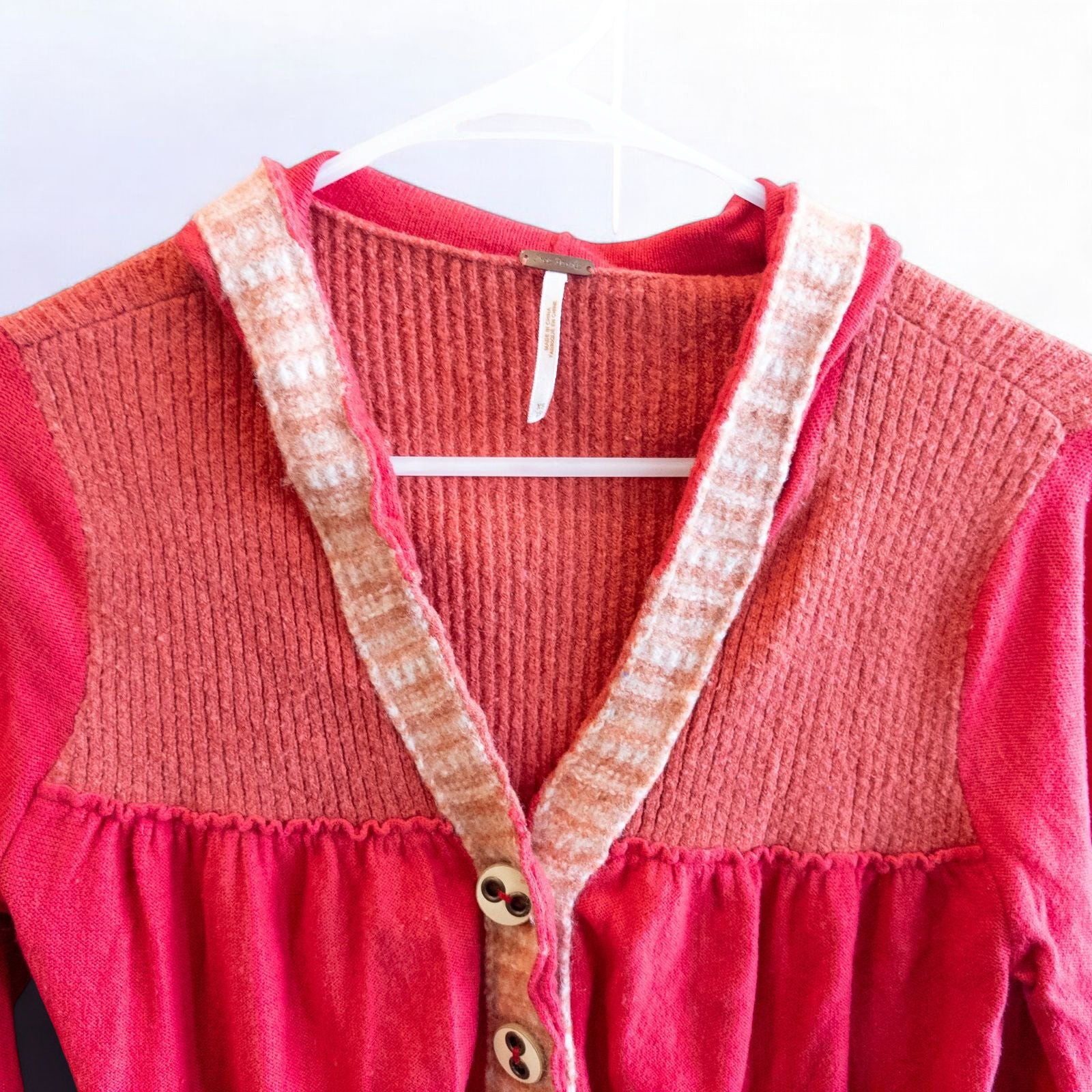 Free People red wool knit cardigan sweater with hood and button front, hung on white hanger image 3