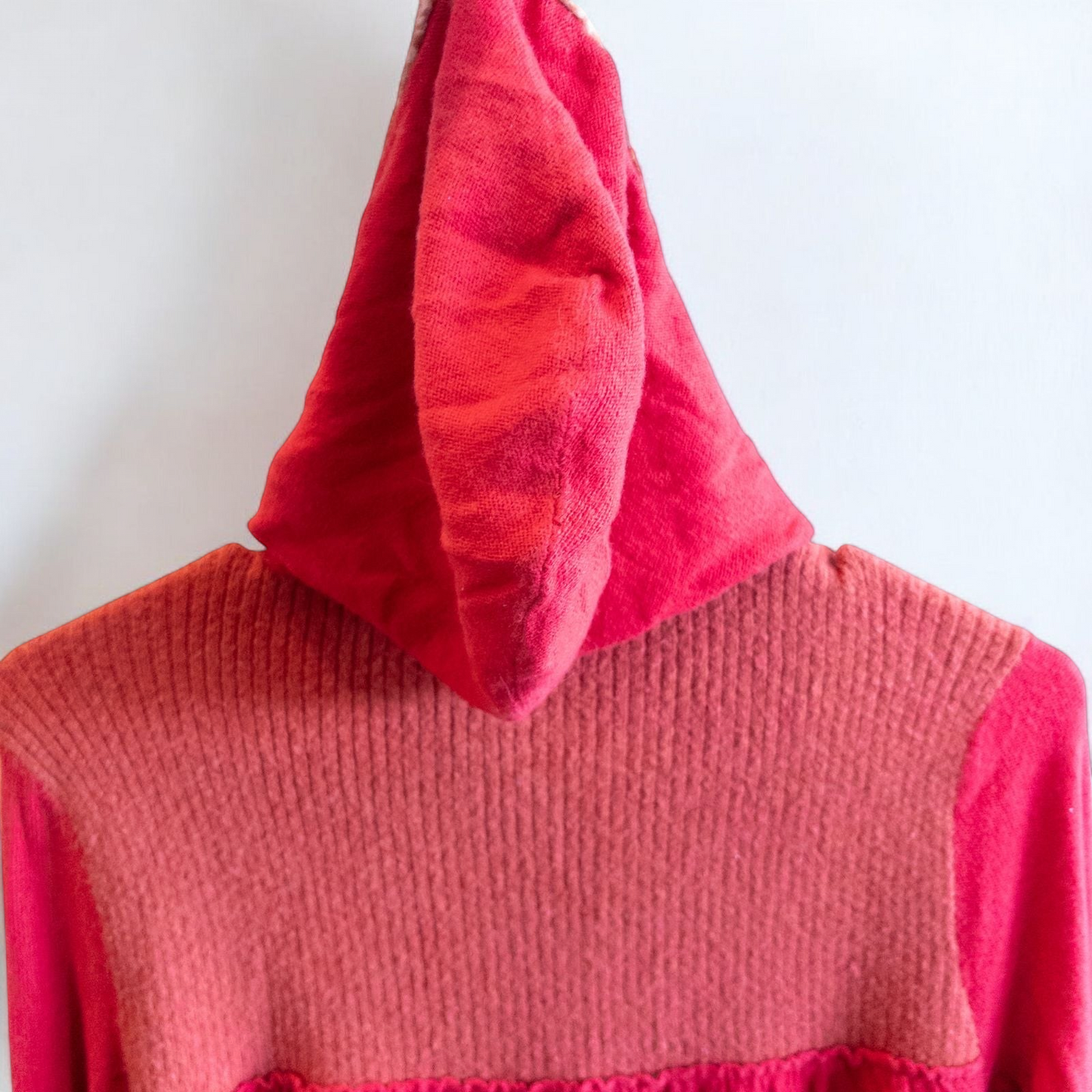 Free People red wool knit cardigan sweater with hood and button front, hung on white hanger image 8