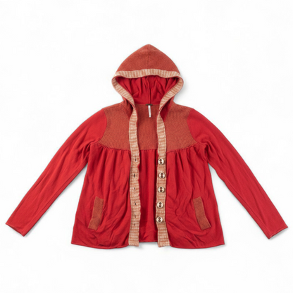Free People red wool knit cardigan sweater with hood and button front, hung on white hanger front on white muslin photography backdrop