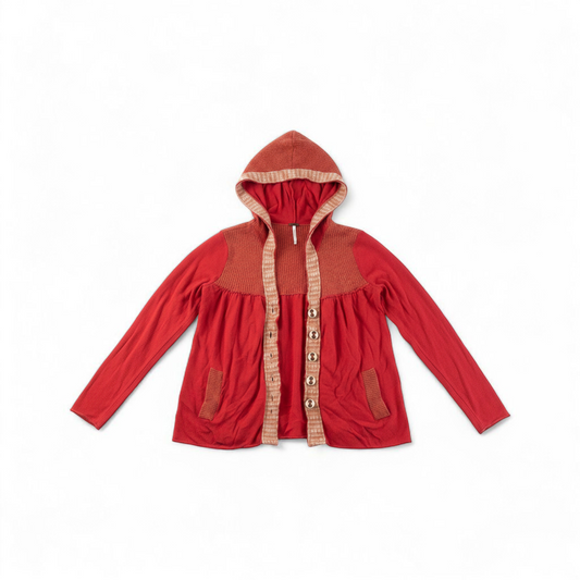 Free People red wool knit cardigan sweater with hood and button front, hung on white hanger front on white muslin photography backdrop