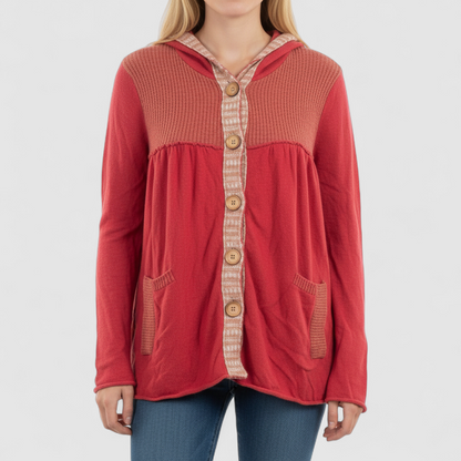 Free People red wool knit cardigan sweater with hood and button front, hung on white hanger on model