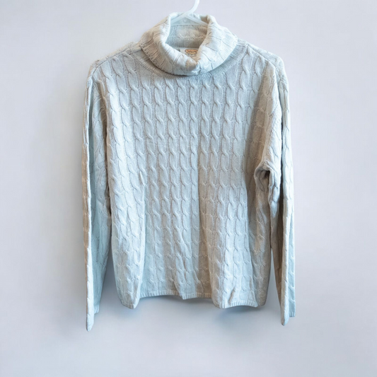 Tan cable knit Talbots turtleneck sweater with silk cashmere blend hanging on a white hanger