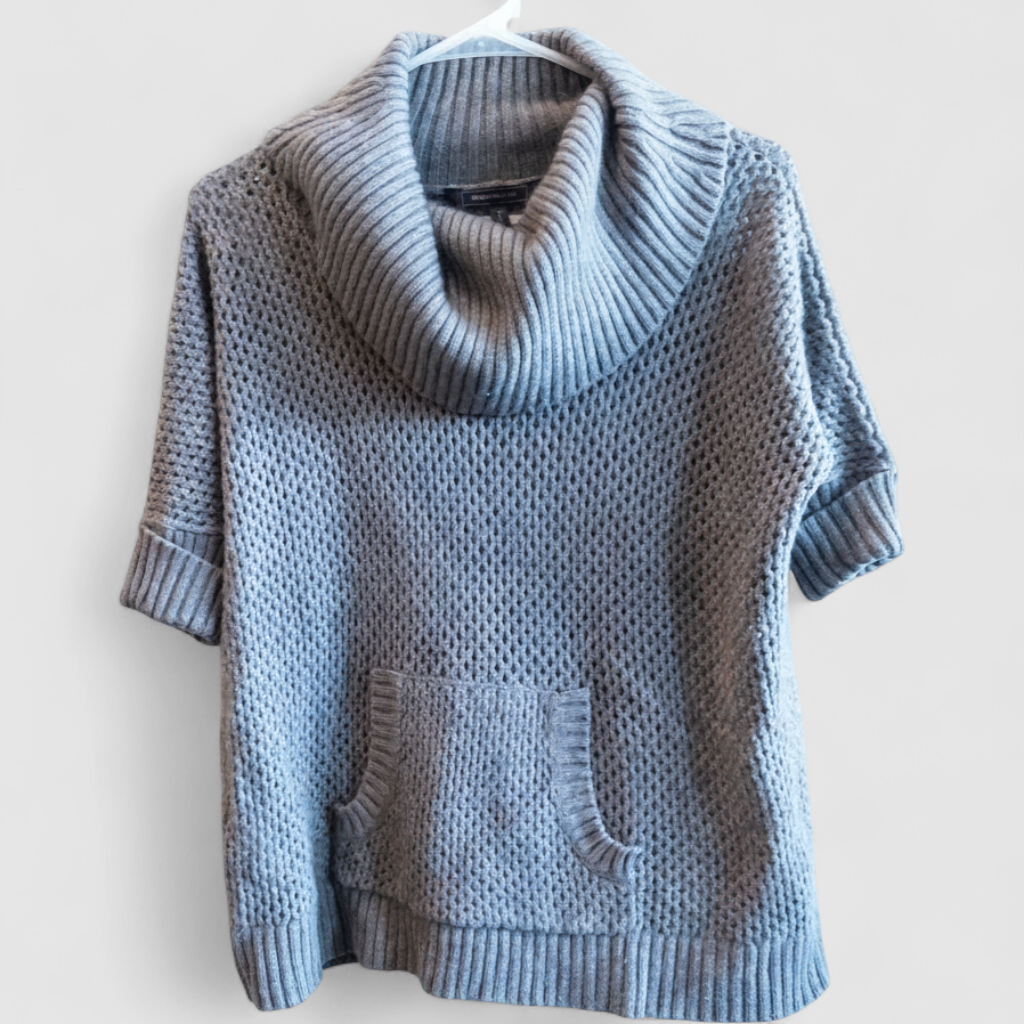 BCBGMaxazria gray dusk open knit cowl neck sweater with short sleeves and front pouch pocket on model