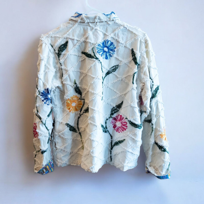 Keren Hart vintage embroidered flower jacket in white with multicolor floral embroidery on a woman and hanging on hangers image 13