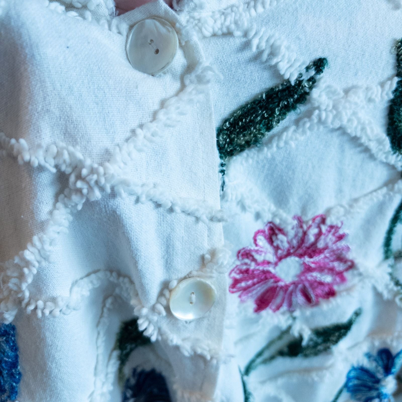 Keren Hart vintage embroidered flower jacket in white with multicolor floral embroidery on a woman and hanging on hangers image 6