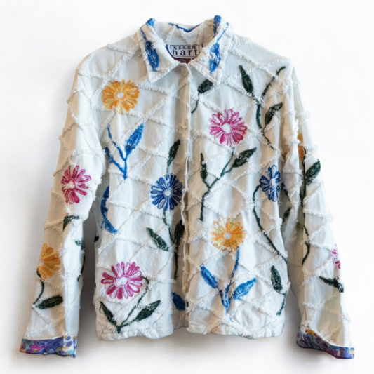 Keren Hart vintage embroidered flower jacket in white with multicolor floral embroidery on a woman and hanging on hangers front on white muslin photography backdrop