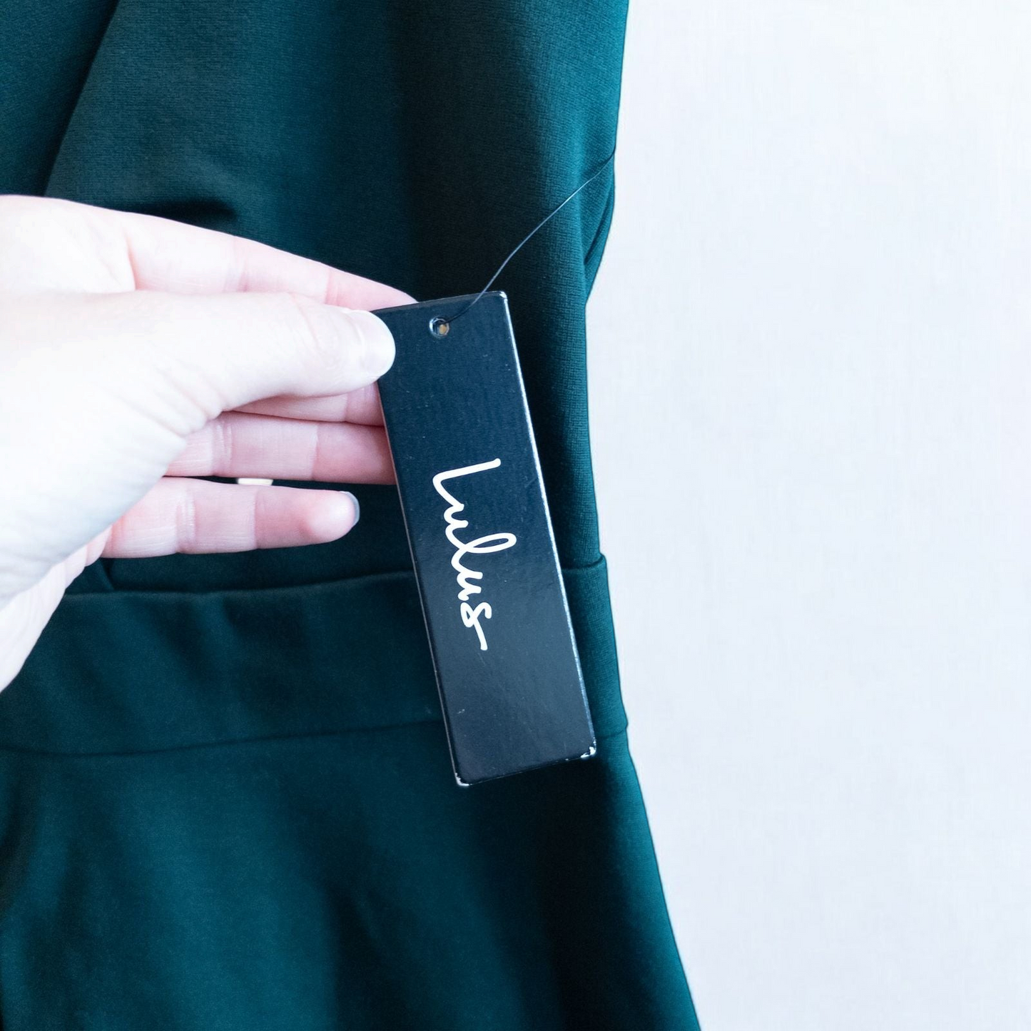 Lulus green sleeveless mini dress with deep v-neck and back zipper hanging on white hanger image 5