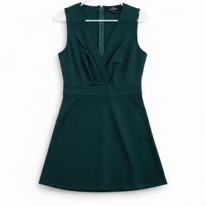 Lulus green sleeveless mini dress with deep v-neck and back zipper hanging on white hanger front on white muslin photography backdrop