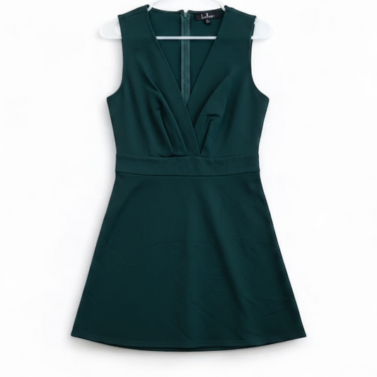 Lulus green sleeveless mini dress with deep v-neck and back zipper hanging on white hanger front on white muslin photography backdrop