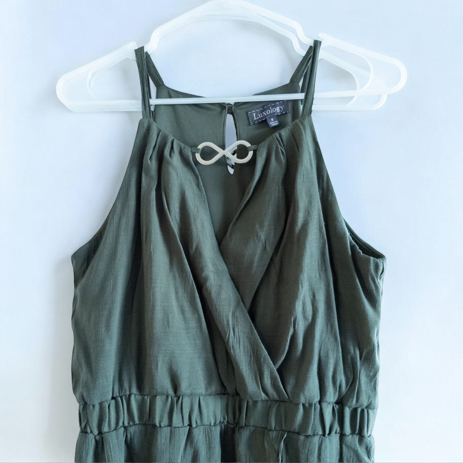 Luxology green slit maxi dress hanging on a hanger in front of a mirror image 2