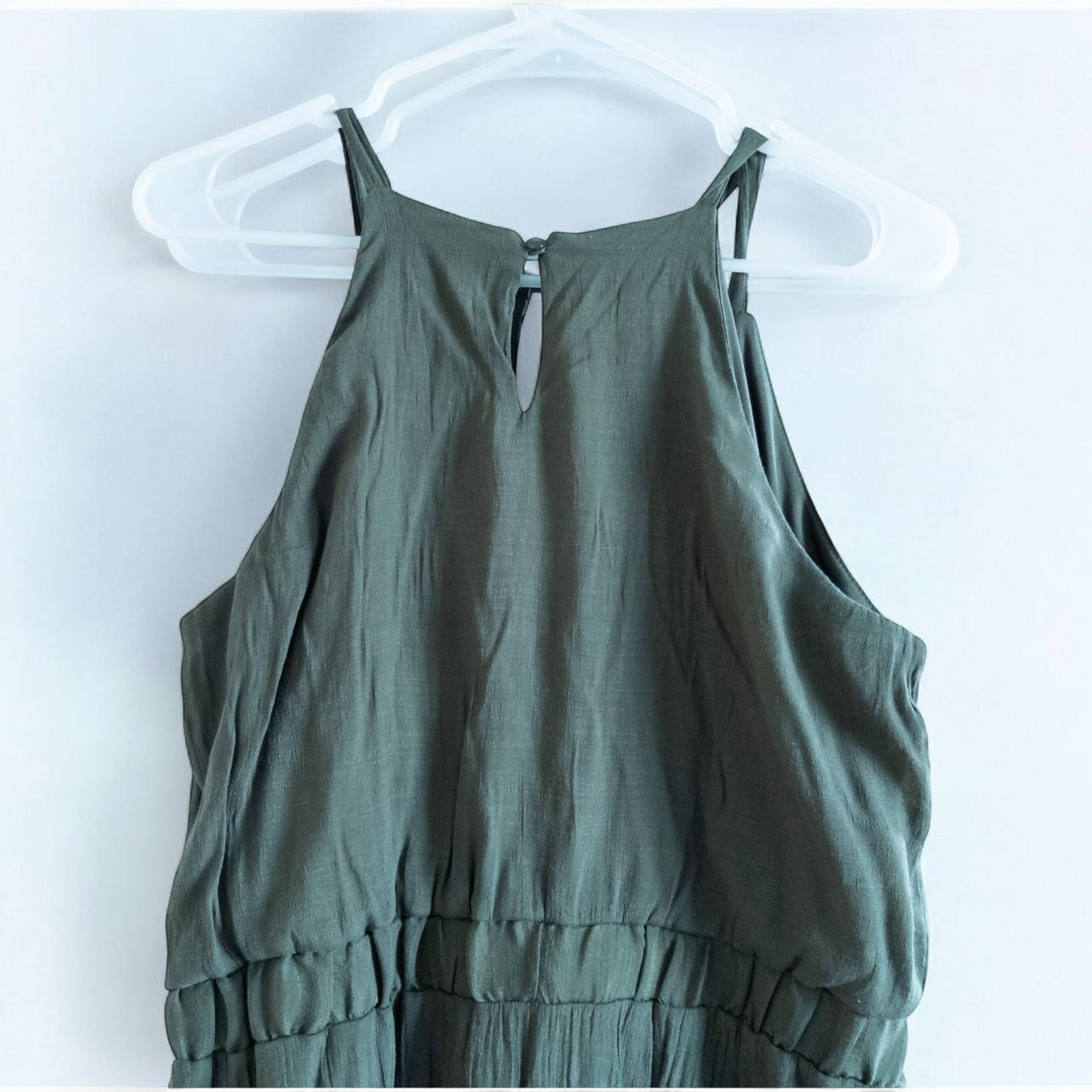 Luxology green slit maxi dress hanging on a hanger in front of a mirror image 6