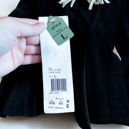 Alex black velvet jacket and skirt set hanging on hanger, showing classic fitted jacket with padded shoulders and flared skirt. image 13
