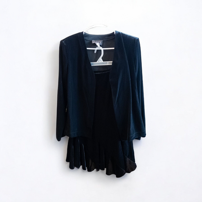 Alex black velvet jacket and skirt set hanging on hanger, showing classic fitted jacket with padded shoulders and flared skirt.