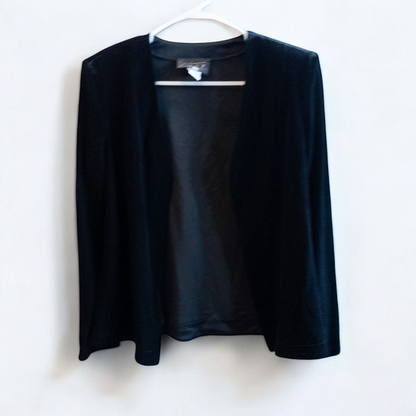 Alex black velvet jacket and skirt set hanging on hanger, showing classic fitted jacket with padded shoulders and flared skirt. image 2