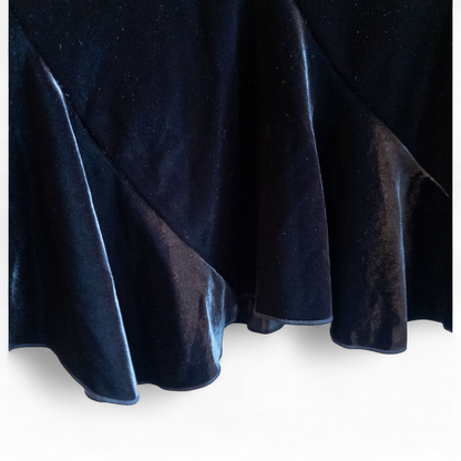 Alex black velvet jacket and skirt set hanging on hanger, showing classic fitted jacket with padded shoulders and flared skirt. image 7
