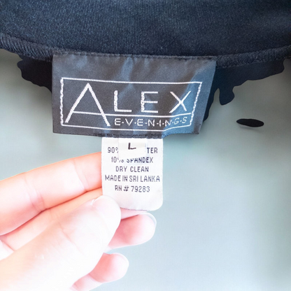 Alex black velvet jacket and skirt set hanging on hanger, showing classic fitted jacket with padded shoulders and flared skirt. image 9
