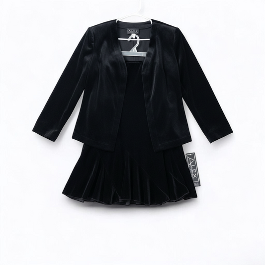 Alex black velvet jacket and skirt set hanging on hanger, showing classic fitted jacket with padded shoulders and flared skirt. front on white muslin photography backdrop