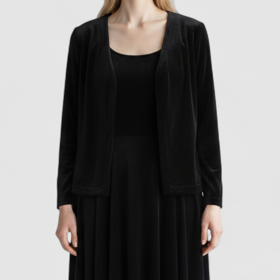 Alex black velvet jacket and skirt set hanging on hanger, showing classic fitted jacket with padded shoulders and flared skirt. on model