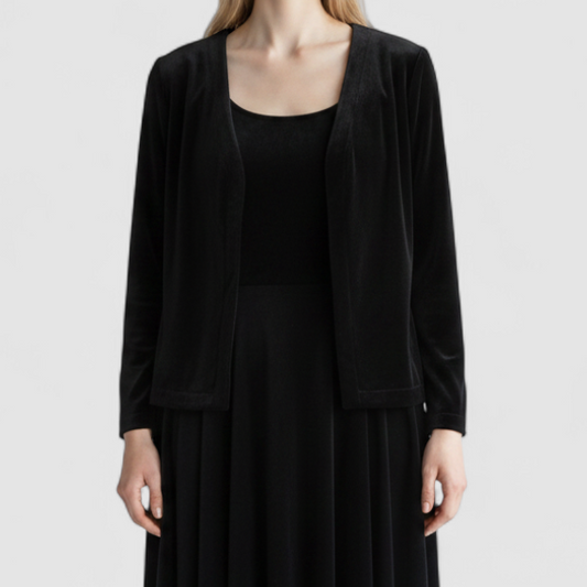 Alex black velvet jacket and skirt set hanging on hanger, showing classic fitted jacket with padded shoulders and flared skirt. on model