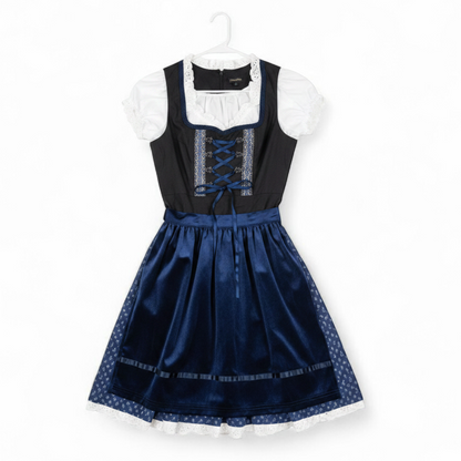 Glorystar vintage German Oktoberfest costume black dress with lace blouse and blue apron set hanging on white door front on white muslin photography backdrop