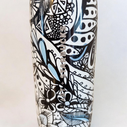 Starbucks Swizzle bottle with black white and blue artistic floral abstract print on countertop image 2