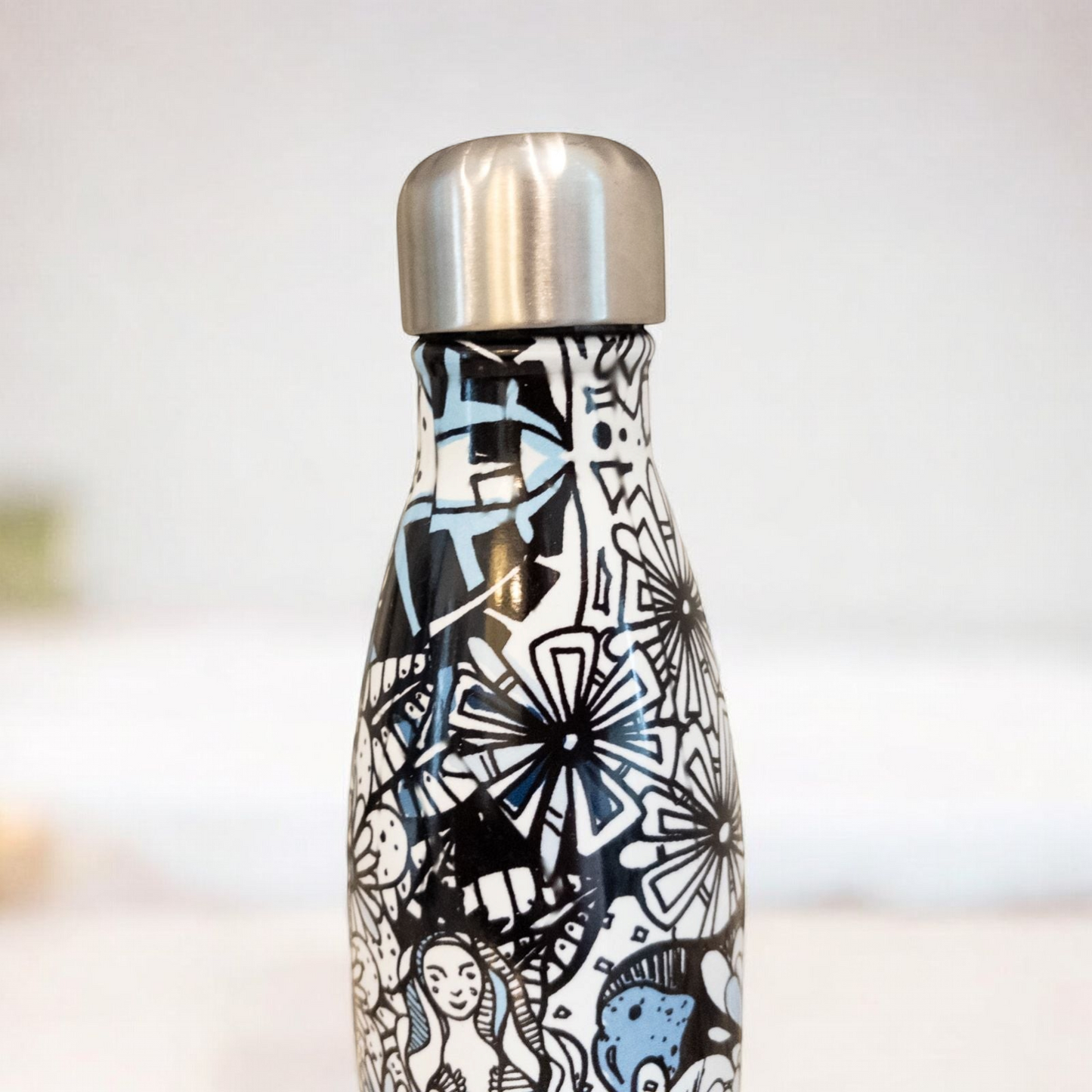 Starbucks Swizzle bottle with black white and blue artistic floral abstract print on countertop image 7