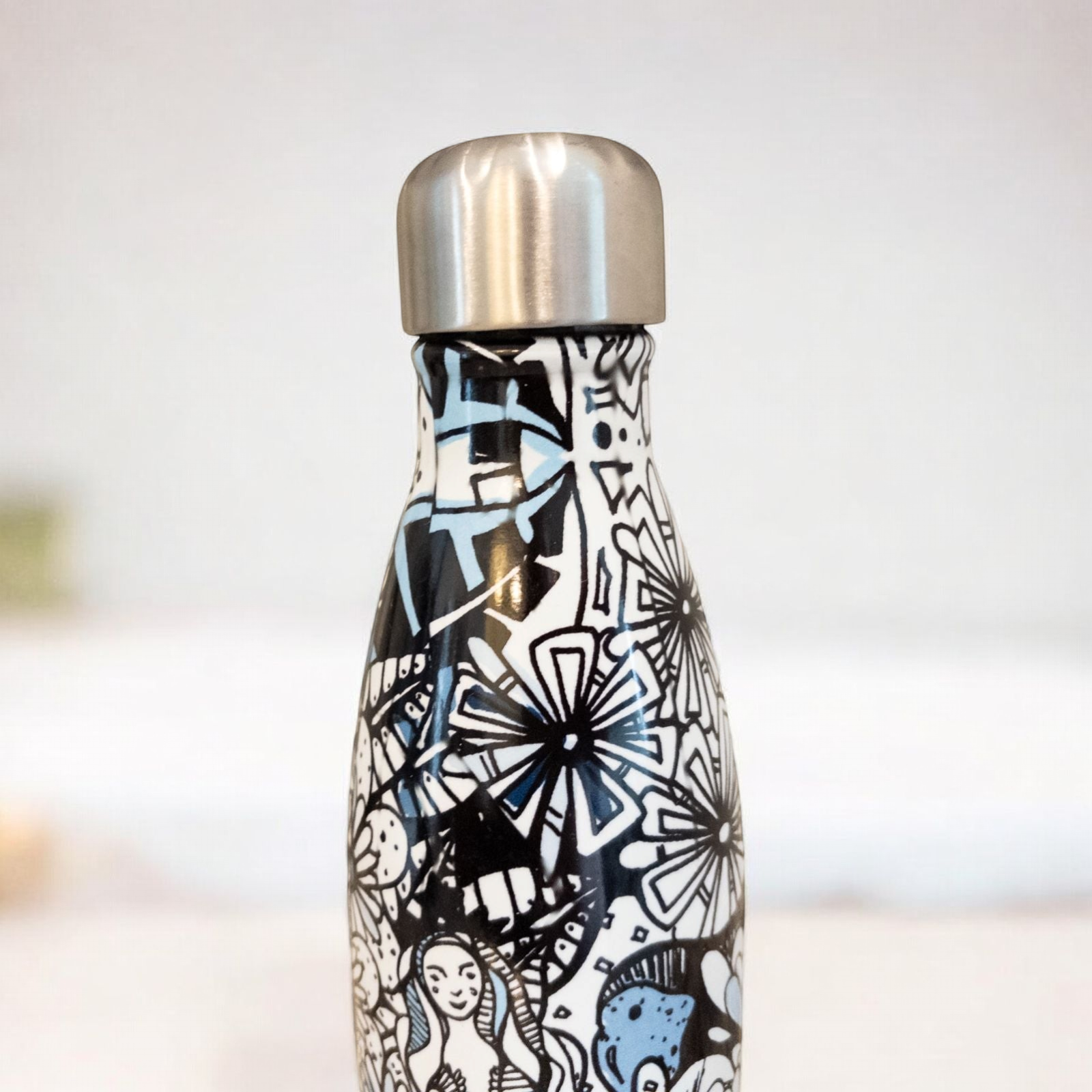Starbucks Swizzle bottle with black white and blue artistic floral abstract print on countertop image 7