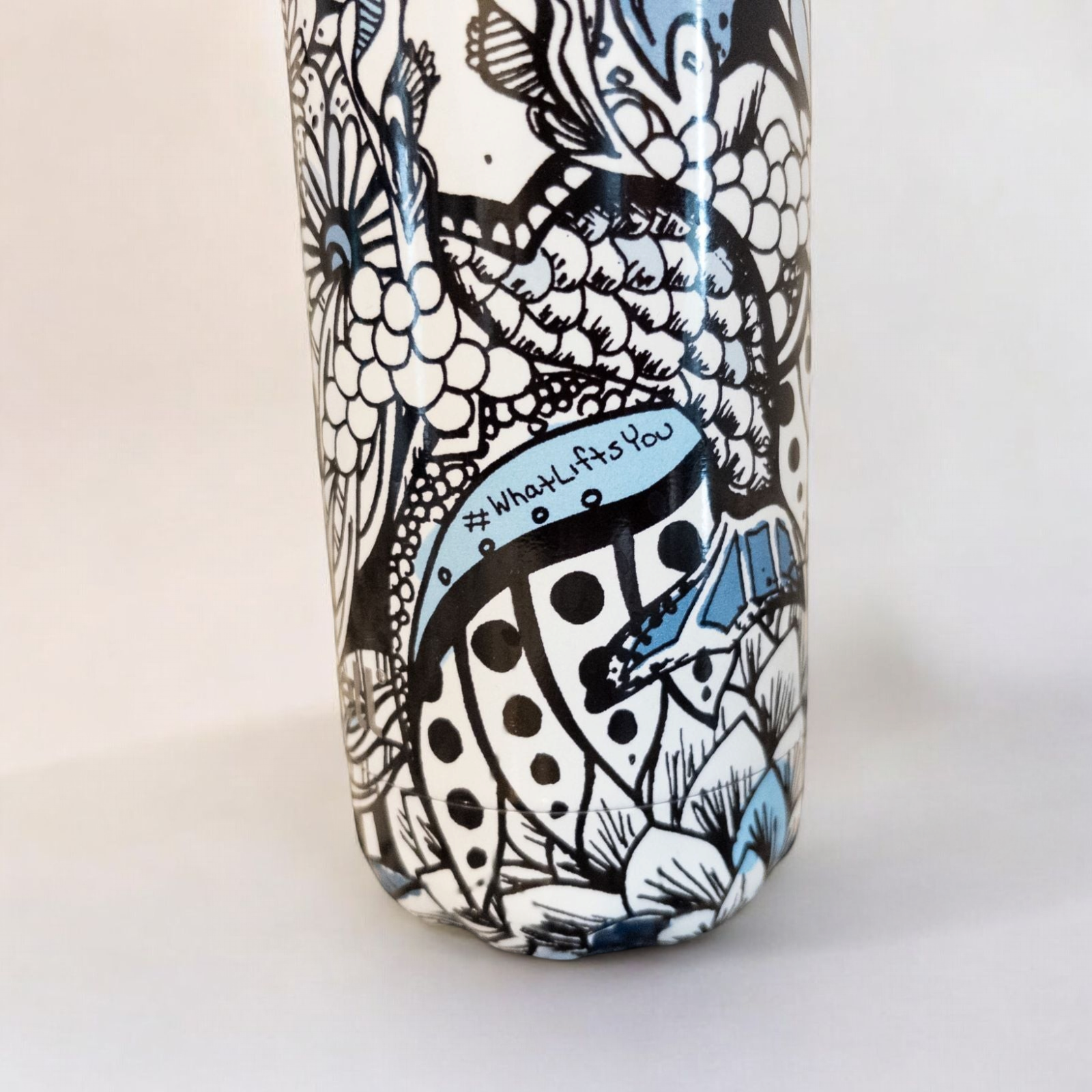 Starbucks Swizzle bottle with black white and blue artistic floral abstract print on countertop image 8