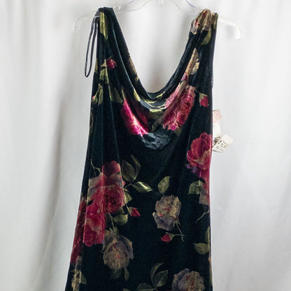 Vintage Jeffrey & Dara red rose velvet evening dress size 12 hanging in front of bookshelves showcasing black velvet fabric with red and purple rose floral pattern and cowl neckline. image 2