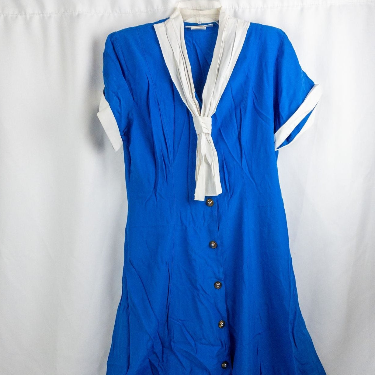Piccalino vintage blue long sailor dress with white collar and cuff accents, button front, and short sleeves laid flat.